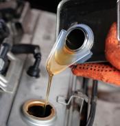Mechanic pours oil into engine